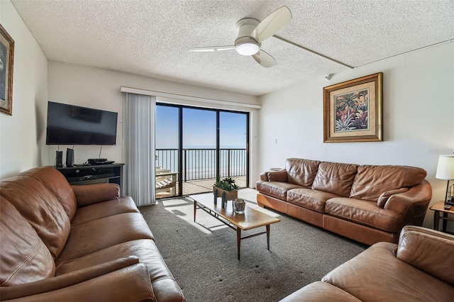 14950 Gulf Blvd Unit 404, Madeira Beach, FL 33708 - living room featuring ceiling fan, carpet, and a textured ceiling