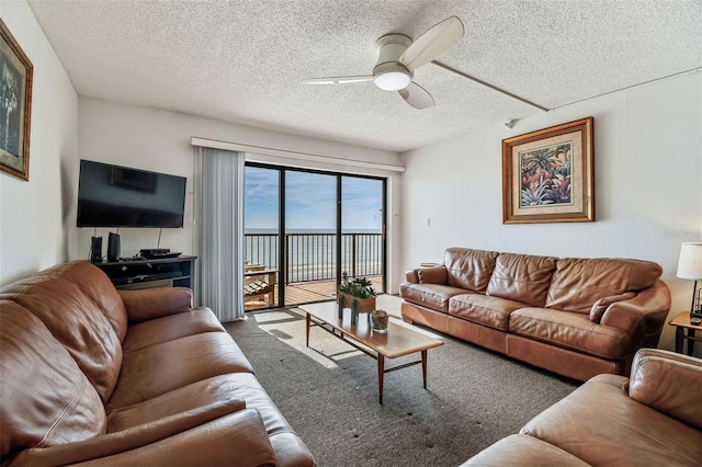 14950 Gulf Blvd Unit 404, Madeira Beach, FL 33708 - carpeted living room with ceiling fan and a textured ceiling