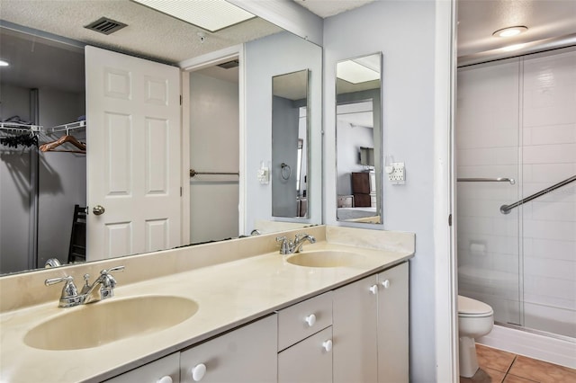 14950 Gulf Blvd Unit 404, Madeira Beach, FL 33708 - full bathroom featuring a stall shower, toilet, double vanity, and tile patterned flooring