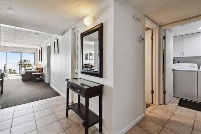 14950 Gulf Blvd Unit 404, Madeira Beach, FL 33708 - hall featuring a textured ceiling, light tile patterned floors, baseboards, and light carpet