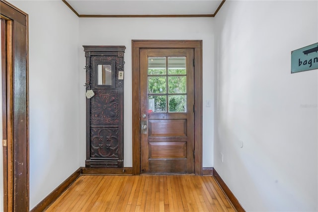 doorway featuring ornamental molding and wood-type flooring