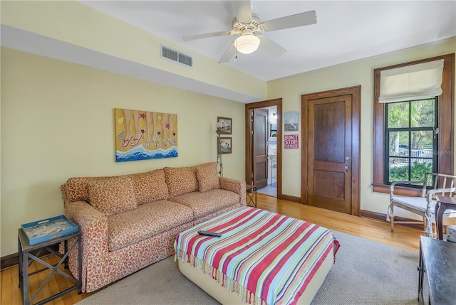 living room with light hardwood / wood-style flooring and ceiling fan