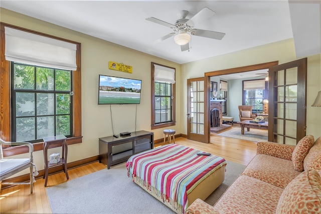 living room with french doors, light hardwood / wood-style flooring, and ceiling fan