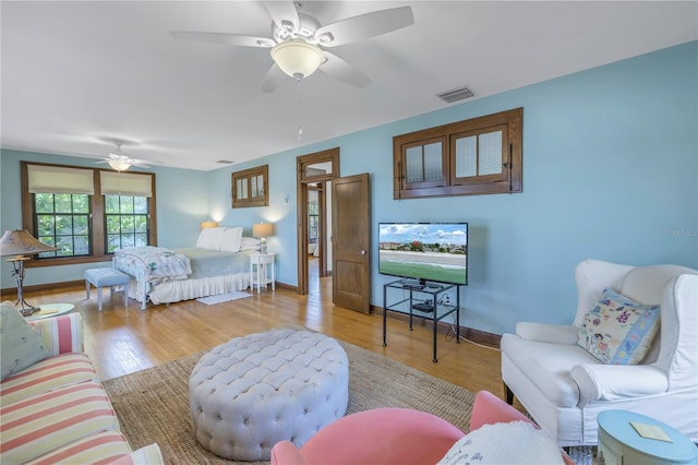 bedroom with ceiling fan and light hardwood / wood-style floors