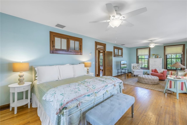 bedroom with light hardwood / wood-style flooring and ceiling fan