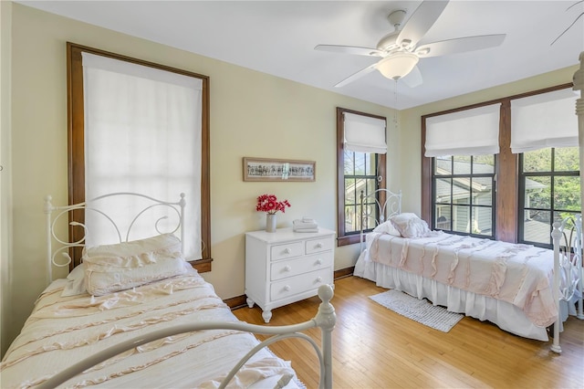 bedroom with light wood-type flooring and ceiling fan