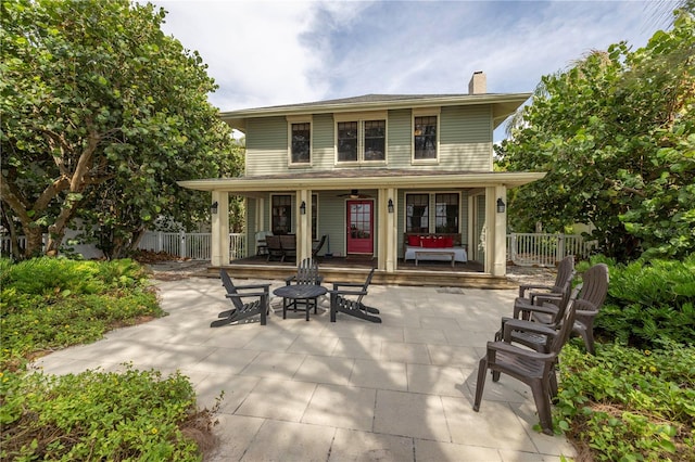 back of property with covered porch