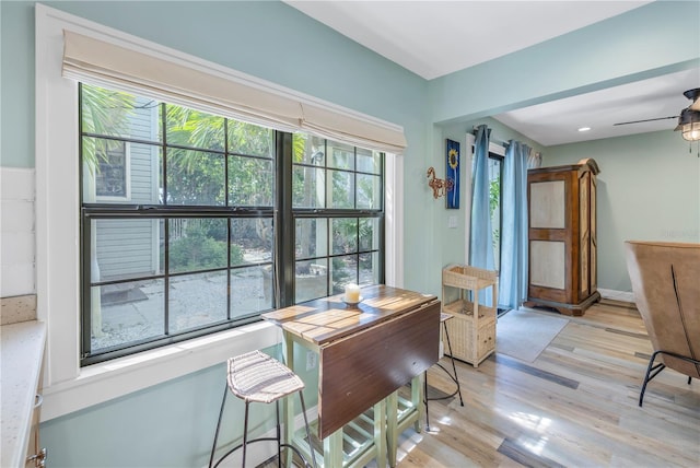 dining space featuring light wood-type flooring and ceiling fan