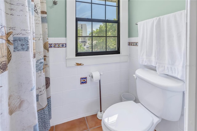 bathroom with tile walls, tile patterned flooring, toilet, and a shower with shower curtain