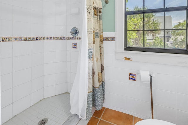 bathroom with curtained shower and tile patterned floors