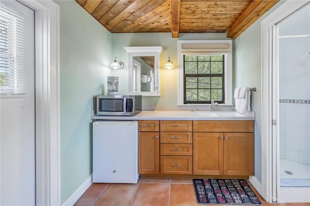 bathroom with tile patterned flooring, vanity, beamed ceiling, and wooden ceiling