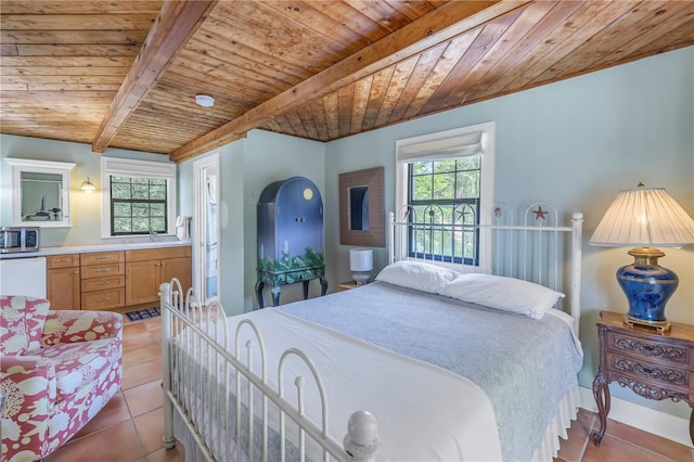 tiled bedroom featuring multiple windows, wood ceiling, beam ceiling, and sink