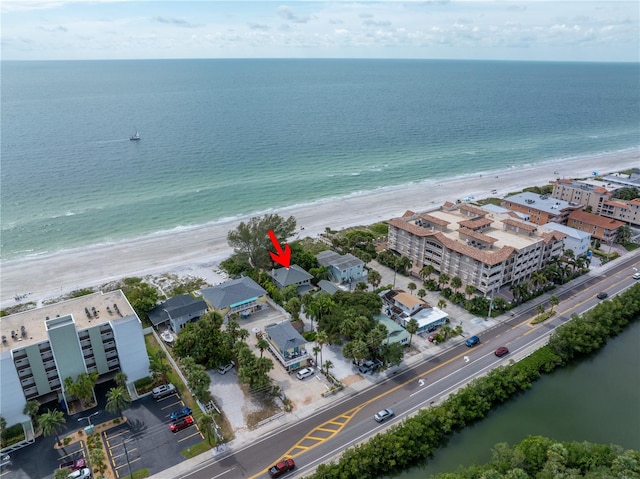 drone / aerial view featuring a beach view and a water view