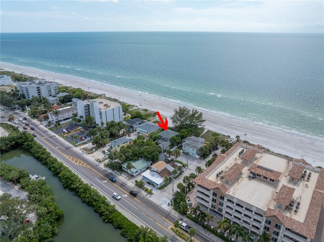 birds eye view of property with a view of the beach and a water view