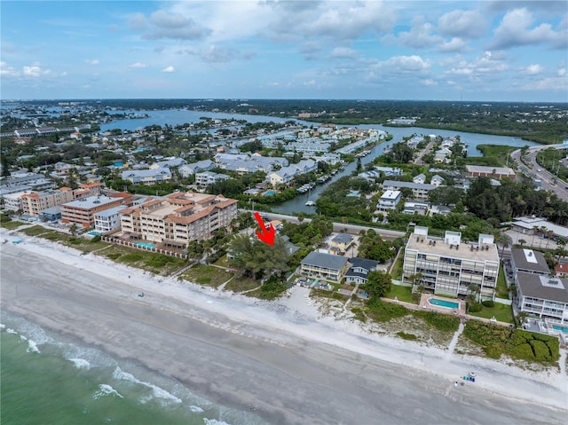 birds eye view of property with a water view and a view of the beach