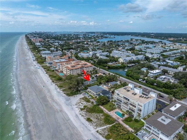 birds eye view of property with a view of the beach and a water view