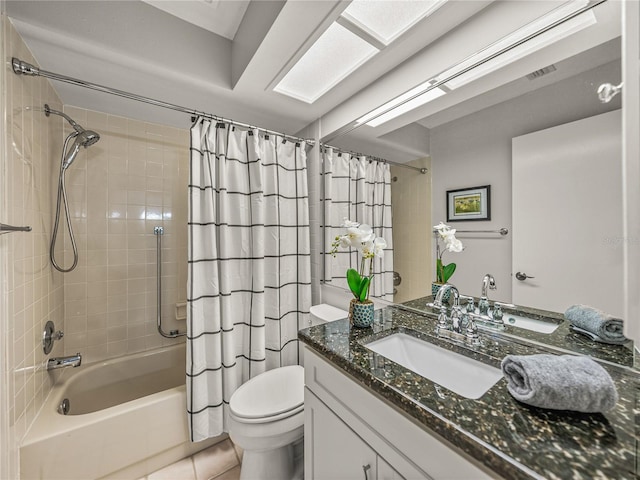 full bathroom with tile patterned flooring, toilet, shower / tub combo with curtain, and vanity