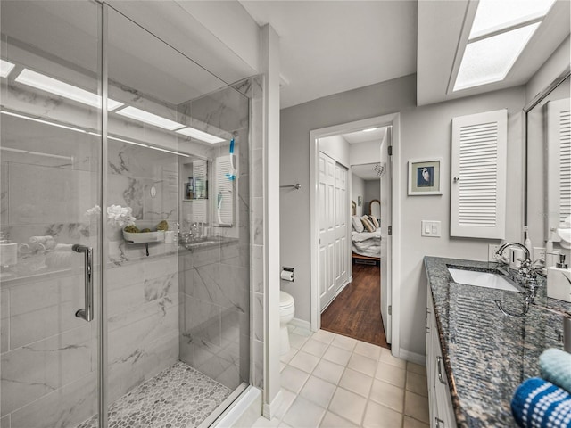 bathroom with a shower with shower door, toilet, hardwood / wood-style floors, and vanity