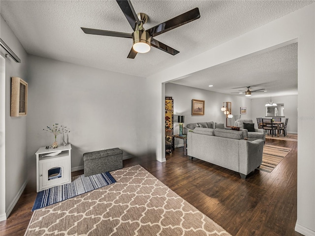 interior space with dark wood-type flooring, a textured ceiling, and ceiling fan