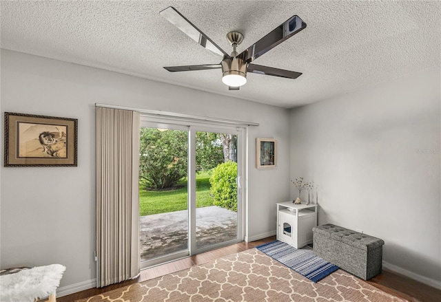 interior space featuring a textured ceiling, hardwood / wood-style floors, and ceiling fan