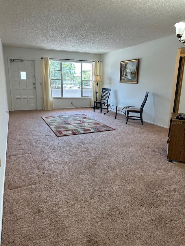 unfurnished room featuring a textured ceiling and carpet flooring