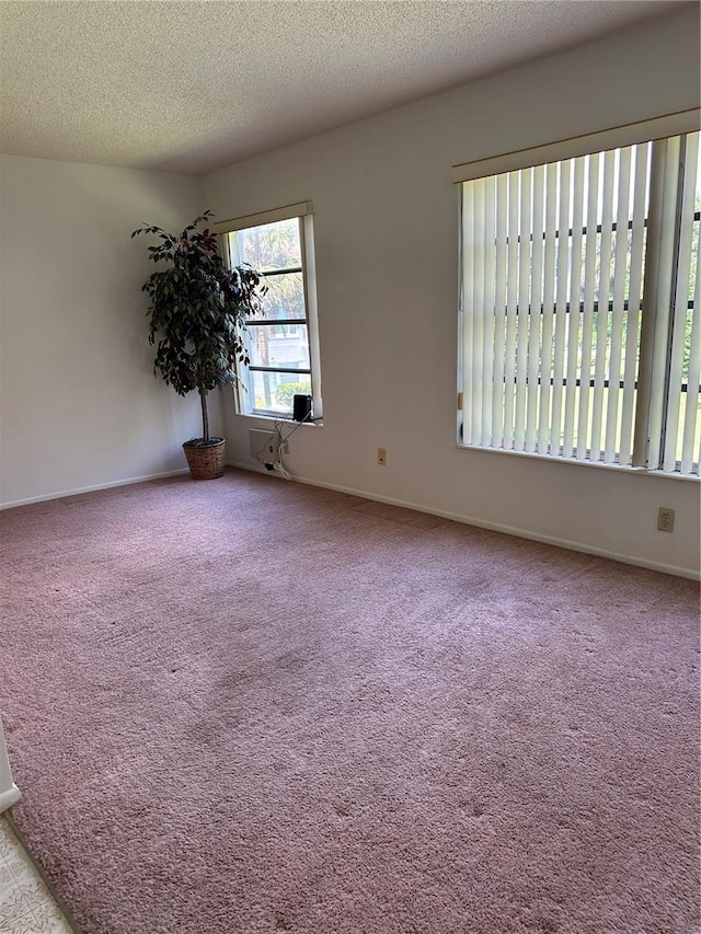 carpeted spare room featuring a textured ceiling