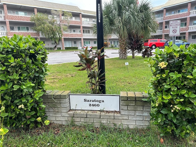 community / neighborhood sign with a lawn