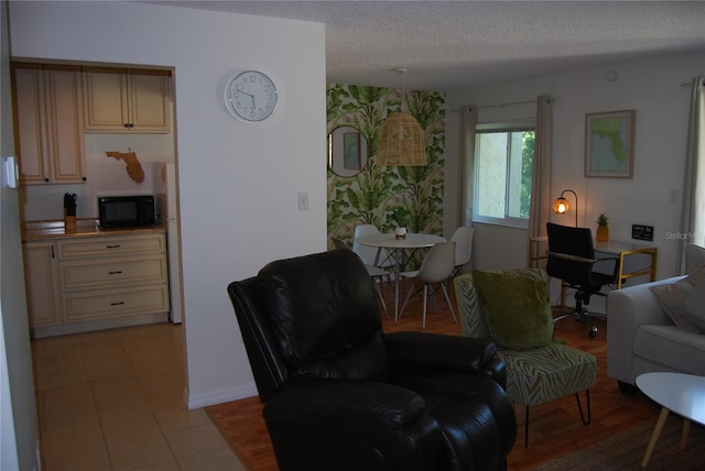 tiled living room featuring a textured ceiling