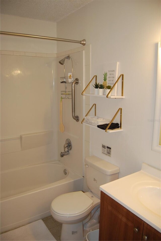 full bathroom with a textured ceiling, vanity, toilet,  shower combination, and tile patterned floors