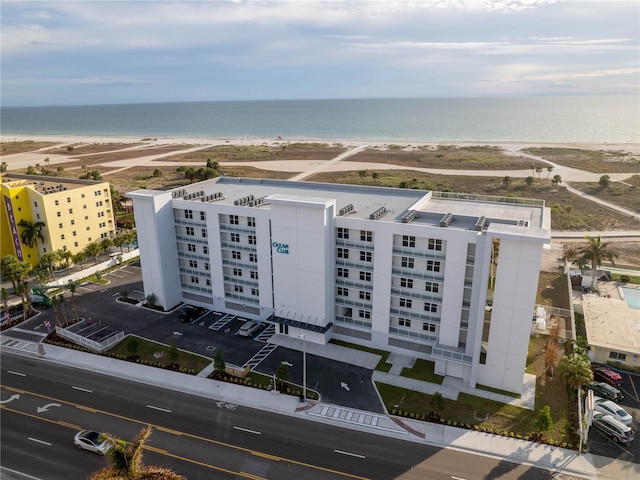 drone / aerial view featuring a water view and a view of the beach