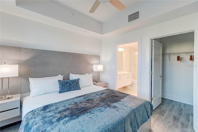 bedroom featuring light wood-type flooring, a closet, and ceiling fan