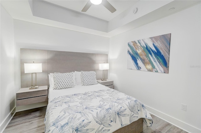 bedroom with light wood-type flooring and ceiling fan