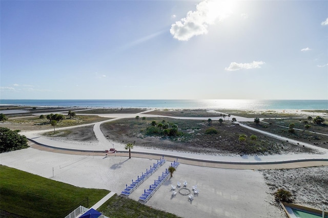 drone / aerial view with a water view and a beach view