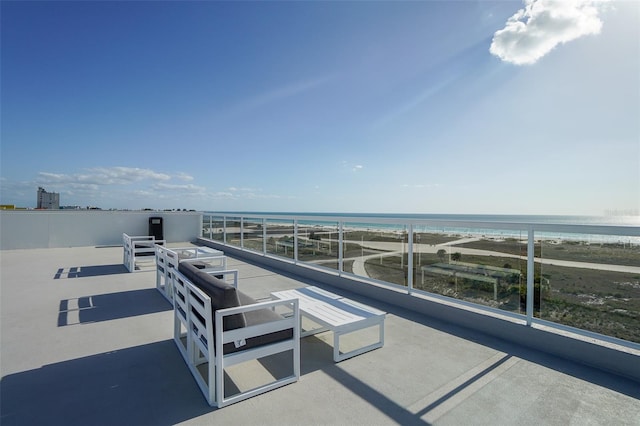 view of patio / terrace featuring a view of the beach and a water view