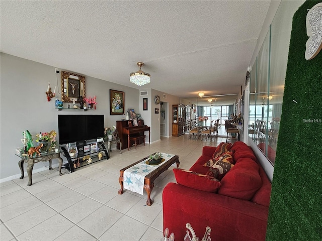 living room featuring a textured ceiling and light tile patterned floors