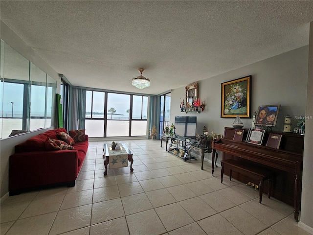 living room featuring floor to ceiling windows, light tile patterned floors, and a textured ceiling