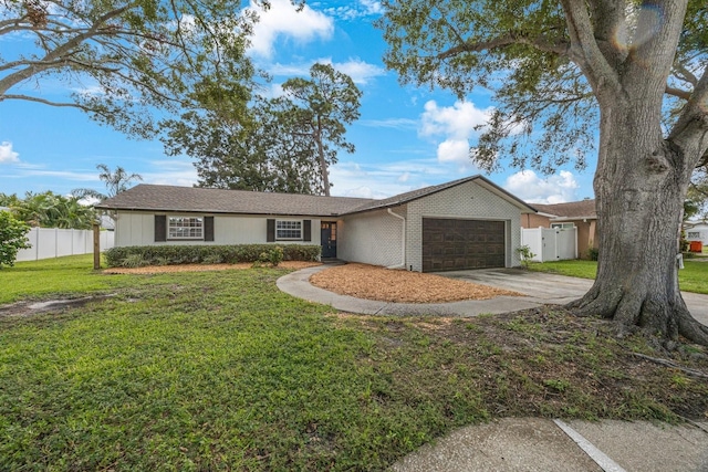 ranch-style house with a garage and a front lawn