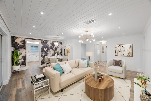 living room featuring light wood-type flooring, an inviting chandelier, and wooden ceiling