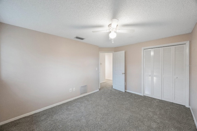 unfurnished bedroom featuring a textured ceiling, ceiling fan, a closet, and carpet floors