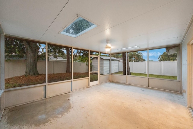 unfurnished sunroom featuring a skylight