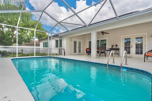 view of pool with ceiling fan, a lanai, a patio area, and french doors