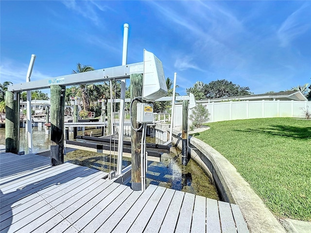 dock area featuring a water view and a lawn