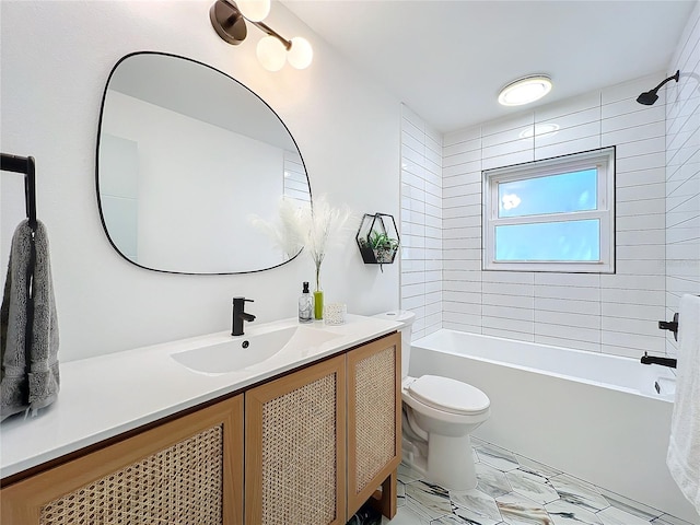 full bathroom with tiled shower / bath, vanity, and toilet