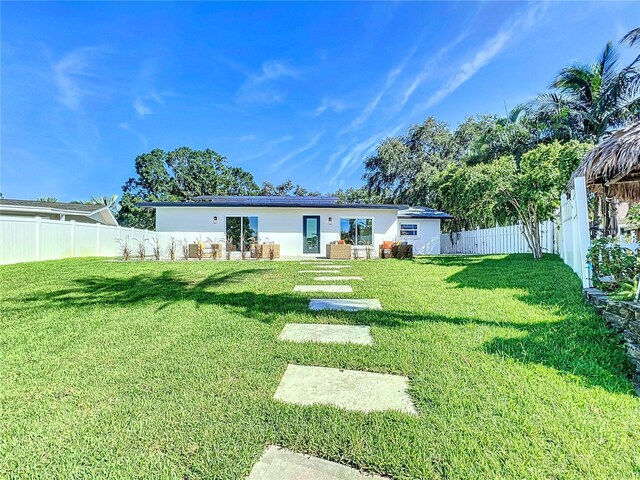 back of house featuring a yard