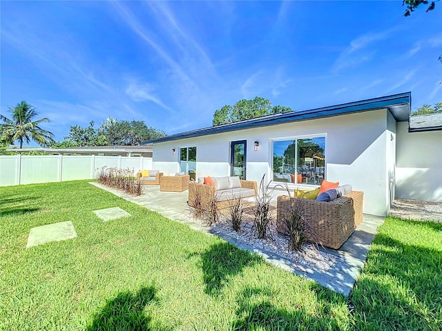 rear view of house with an outdoor hangout area, a lawn, and a patio