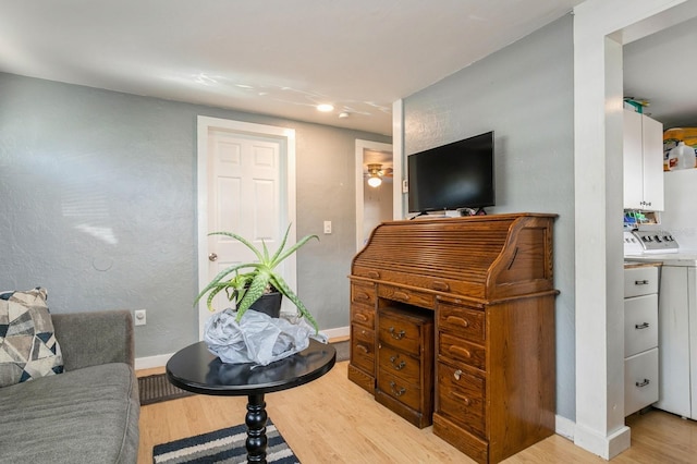 living room with light wood-type flooring and separate washer and dryer