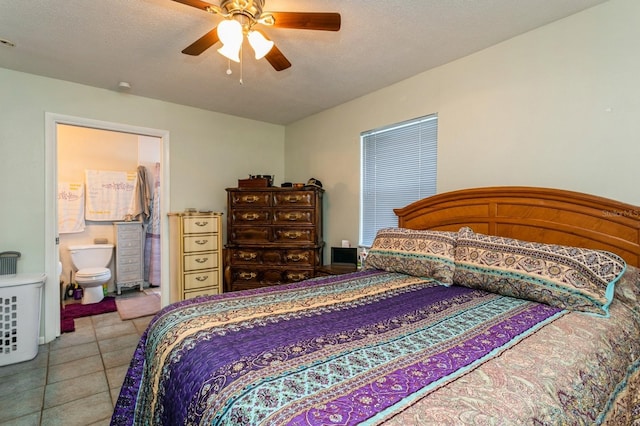 bedroom featuring ceiling fan, light tile patterned floors, a textured ceiling, and ensuite bathroom