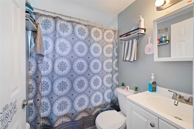 bathroom with a shower with curtain, vanity, and toilet