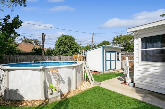 view of swimming pool with a lawn and a storage unit