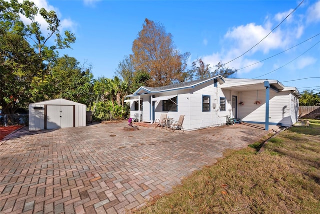 exterior space featuring a storage shed and a front yard